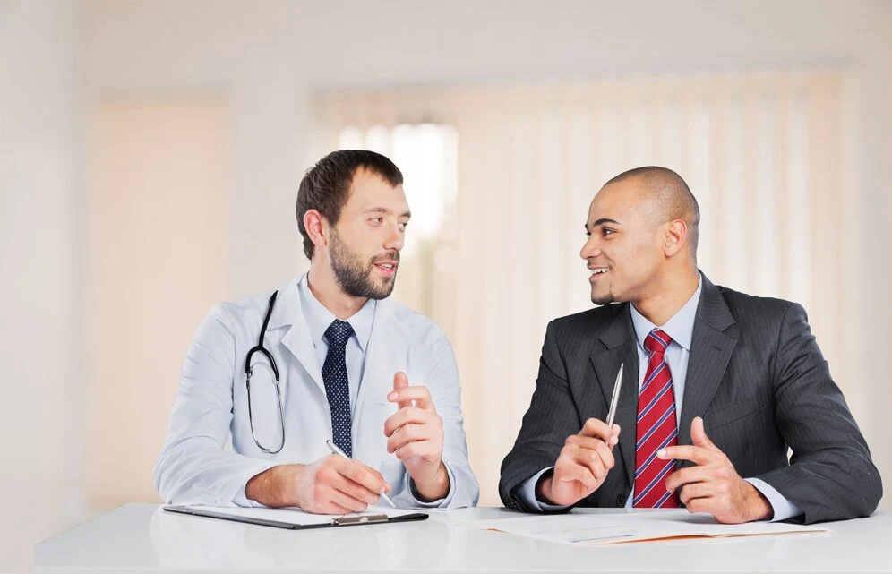 lawyer discussing with doctor regarding medical lawsuit.